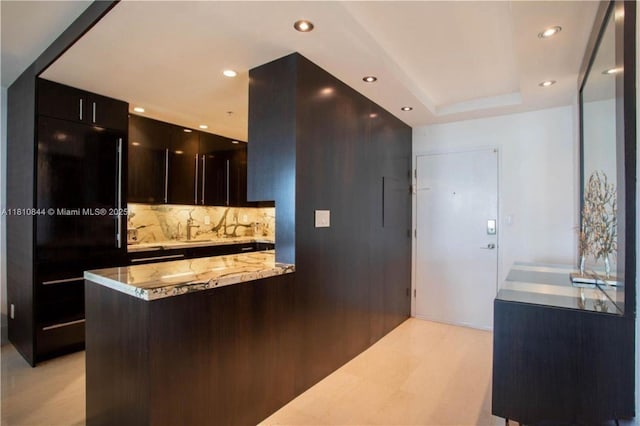 100 Lincoln Rd Unit 647, Miami Beach, FL 33139 - kitchen with tasteful backsplash, modern cabinets, a sink, light stone counters, and recessed lighting