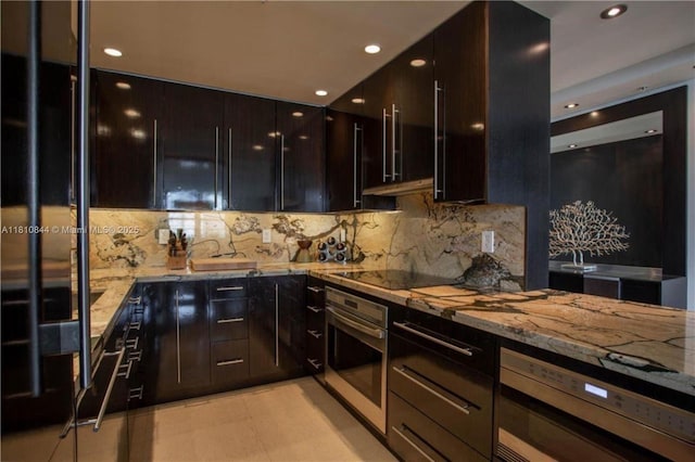 100 Lincoln Rd Unit 647, Miami Beach, FL 33139 - kitchen with appliances with stainless steel finishes, modern cabinets, light stone counters, tasteful backsplash, and recessed lighting