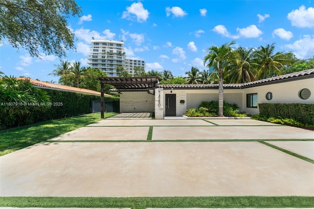 4250 Bay Point Rd, Miami, FL 33137 - view of front of home with a pergola, concrete driveway, and a tile roof
