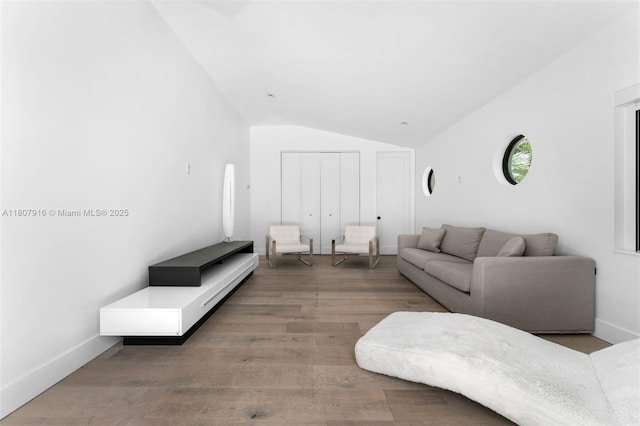 4250 Bay Point Rd, Miami, FL 33137 - living area with lofted ceiling, wood finished floors, and baseboards
