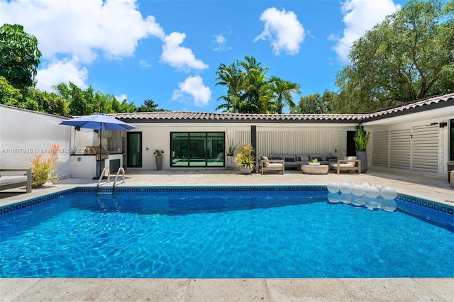 4250 Bay Point Rd, Miami, FL 33137 - swimming pool with an outdoor hangout area, a patio area, and an outdoor kitchen