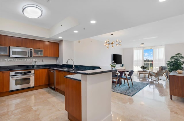 14951 Royal Oaks Ln Unit 901, North Miami, FL 33181 - kitchen with stainless steel appliances, brown cabinetry, a peninsula, modern cabinets, and a sink
