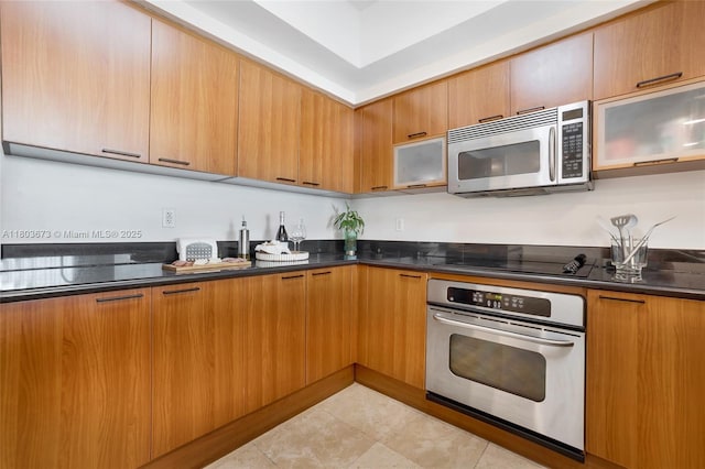 14951 Royal Oaks Ln Unit 901, North Miami, FL 33181 - kitchen with stainless steel appliances, modern cabinets, glass insert cabinets, and brown cabinets