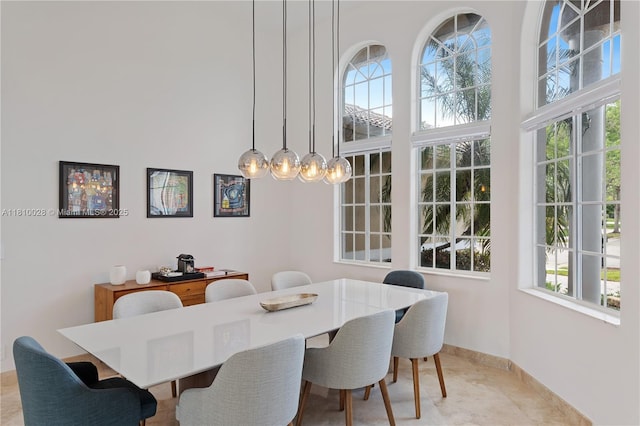 146 Dockside Cir, Weston, FL 33327 - dining space featuring healthy amount of natural light, a towering ceiling, baseboards, and a chandelier