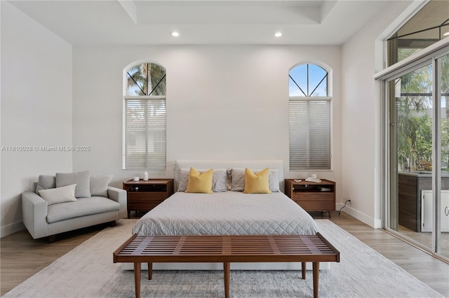 146 Dockside Cir, Weston, FL 33327 - bedroom with recessed lighting, baseboards, light wood-style floors, access to exterior, and a raised ceiling