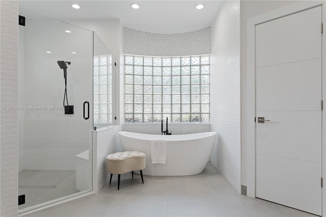 146 Dockside Cir, Weston, FL 33327 - bathroom with a shower stall, a soaking tub, recessed lighting, tile walls, and tile patterned floors