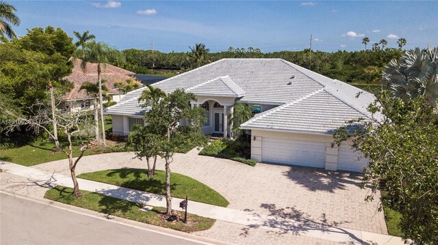 146 Dockside Cir, Weston, FL 33327 - view of front of property with driveway, an attached garage, and a tile roof