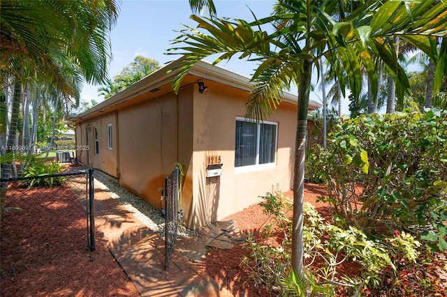 1215-1217 NE 16th Ave, Fort Lauderdale, FL 33304 - view of side of property featuring stucco siding and central air condition unit