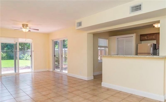 1215-1217 NE 16th Ave, Fort Lauderdale, FL 33304 - empty room with a ceiling fan, baseboards, and light tile patterned flooring