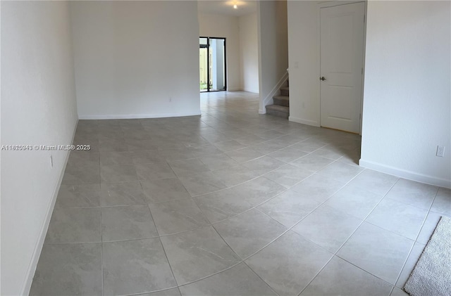 245 SW 159th Ct, Pembroke Pines, FL 33027 - empty room with stairway, light tile patterned floors, and baseboards