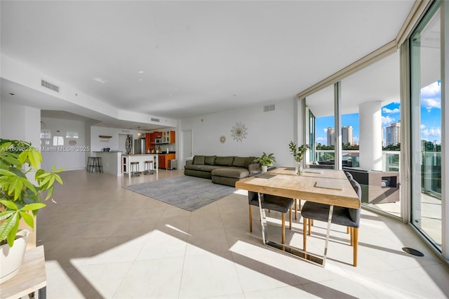 3131 NE 188th St Unit 2-506, Aventura, FL 33180 - living area with light tile patterned floors and a wall of windows
