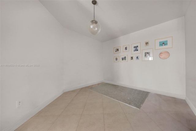 3131 NE 188th St Unit 2-506, Aventura, FL 33180 - empty room featuring baseboards, light tile patterned flooring, and lofted ceiling