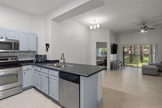3340 Palomino Dr Unit 214-2, Davie, FL 33024 - kitchen featuring appliances with stainless steel finishes, a sink, open floor plan, and dark countertops