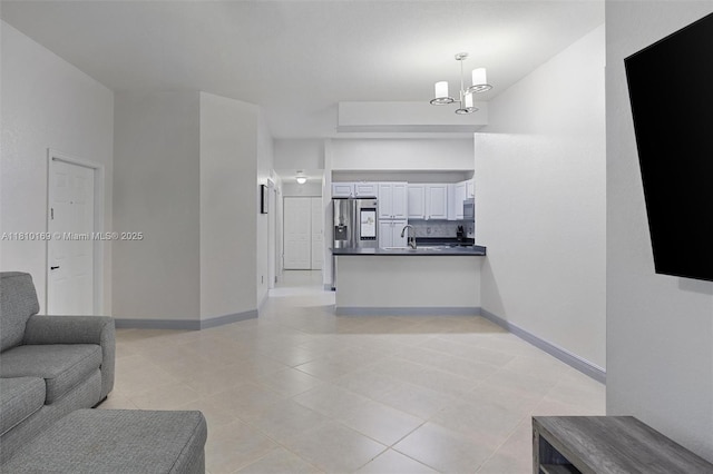 3340 Palomino Dr Unit 214-2, Davie, FL 33024 - living area featuring light tile patterned flooring, baseboards, and a chandelier