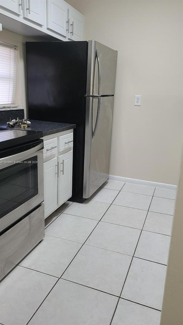 8540 N Sherman Cir Unit 204, Miramar, FL 33025 - kitchen featuring appliances with stainless steel finishes, light tile patterned floors, white cabinets, and dark countertops
