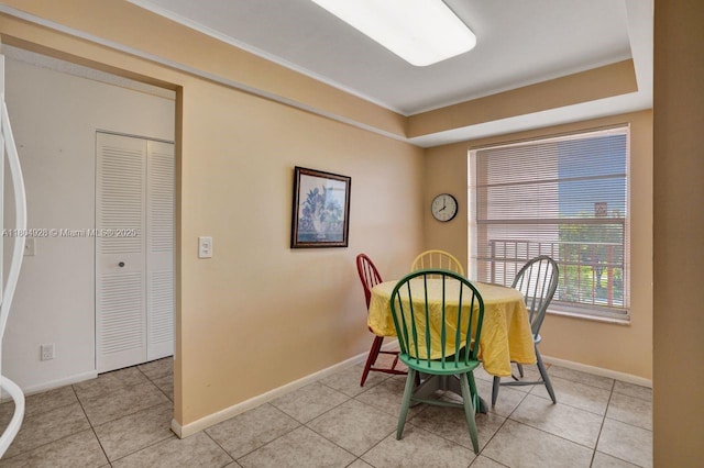 14671 Bonaire Blvd Unit 510, Delray Beach, FL 33446 - dining area featuring baseboards, light tile patterned flooring, a tray ceiling, and ornamental molding