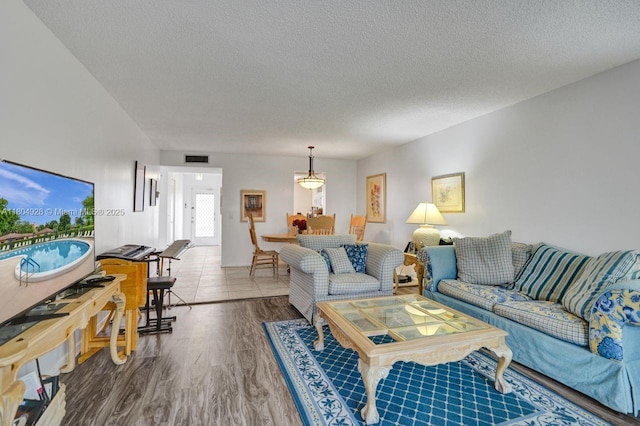 14671 Bonaire Blvd Unit 510, Delray Beach, FL 33446 - living area featuring a textured ceiling and wood finished floors