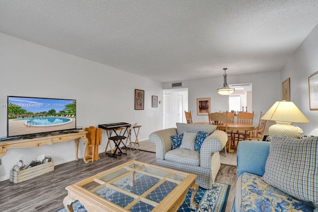 14671 Bonaire Blvd Unit 510, Delray Beach, FL 33446 - living area with wood finished floors, a textured ceiling, and baseboards