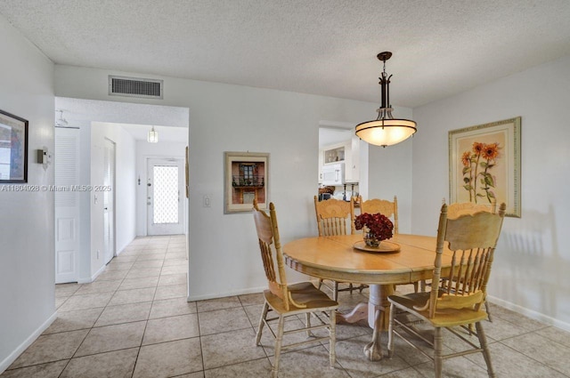 14671 Bonaire Blvd Unit 510, Delray Beach, FL 33446 - dining space featuring light tile patterned floors, a textured ceiling, and baseboards