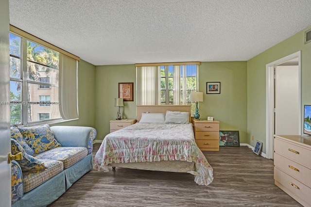 14671 Bonaire Blvd Unit 510, Delray Beach, FL 33446 - bedroom featuring multiple windows, wood finished floors, a textured ceiling, and baseboards