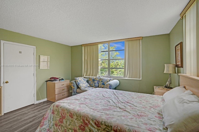 14671 Bonaire Blvd Unit 510, Delray Beach, FL 33446 - bedroom featuring wood finished floors, a textured ceiling, and baseboards