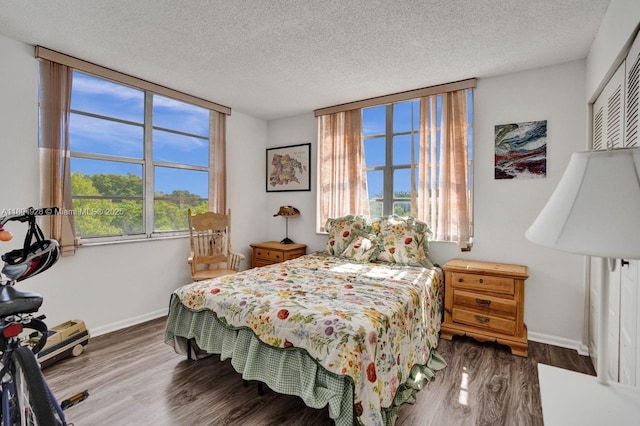 14671 Bonaire Blvd Unit 510, Delray Beach, FL 33446 - bedroom featuring wood finished floors, a textured ceiling, and baseboards