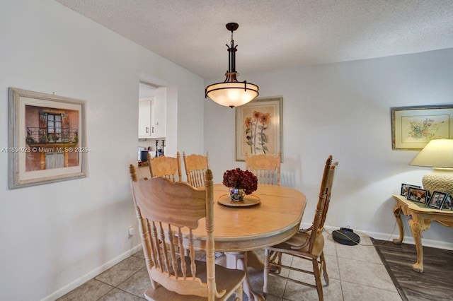 14671 Bonaire Blvd Unit 510, Delray Beach, FL 33446 - dining area with light tile patterned floors, a textured ceiling, and baseboards