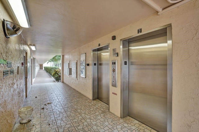14671 Bonaire Blvd Unit 510, Delray Beach, FL 33446 - hall with elevator and a textured wall
