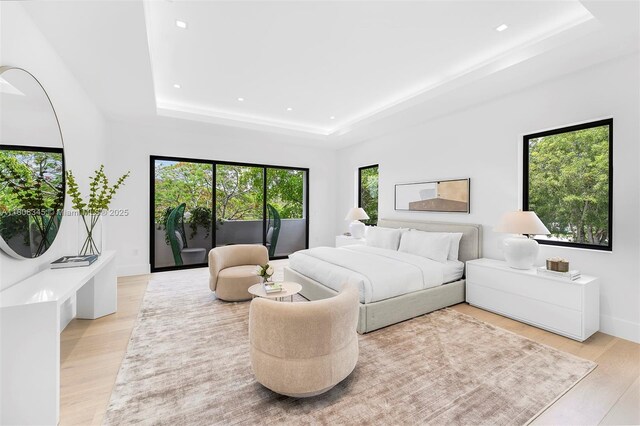 11001 SW 65th Ave, Pinecrest, FL 33156 - bedroom with a tray ceiling, light wood-style flooring, and recessed lighting