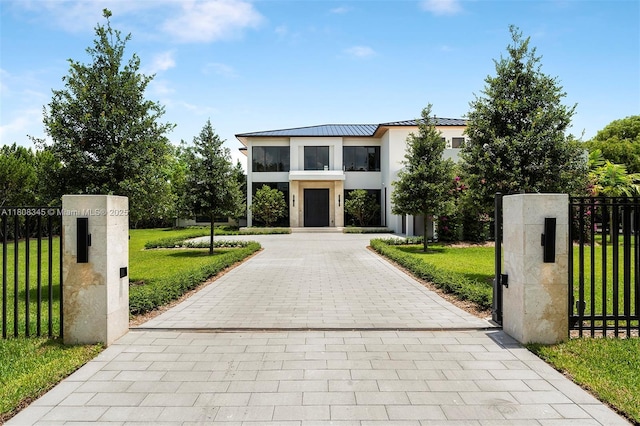 11001 SW 65th Ave, Pinecrest, FL 33156 - modern home featuring a standing seam roof, stucco siding, metal roof, and a gate