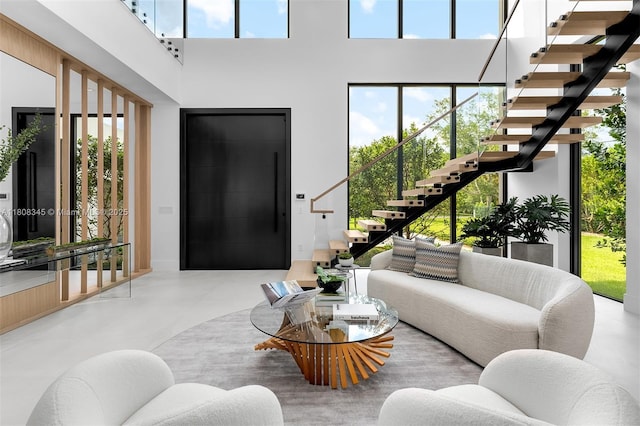 11001 SW 65th Ave, Pinecrest, FL 33156 - living area with stairway, finished concrete floors, and a towering ceiling