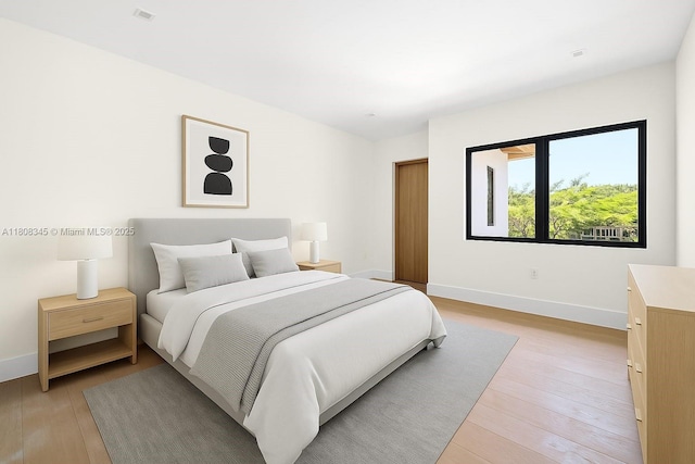 11001 SW 65th Ave, Pinecrest, FL 33156 - bedroom featuring baseboards and light wood-style floors