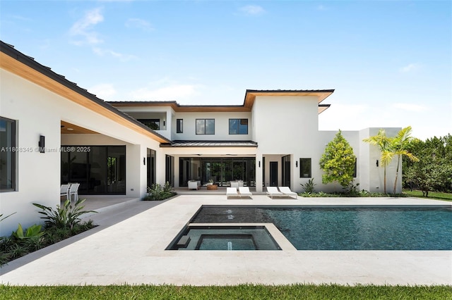 11001 SW 65th Ave, Pinecrest, FL 33156 - rear view of house featuring a patio area, stucco siding, an outdoor pool, and an in-ground hot tub