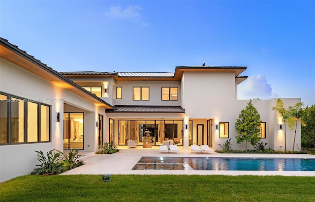 11001 SW 65th Ave, Pinecrest, FL 33156 - rear view of property with a standing seam roof, stucco siding, and a patio area