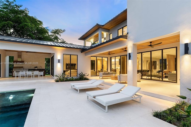 11001 SW 65th Ave, Pinecrest, FL 33156 - back of house featuring an outdoor hangout area, a standing seam roof, ceiling fan, and a patio area