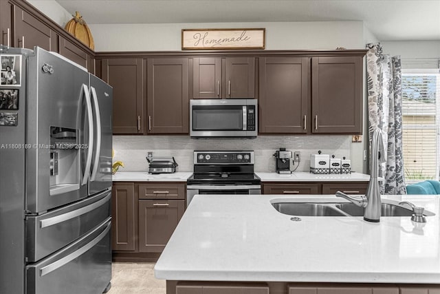 5781 SW 39th St, Ocala, FL 34474 - kitchen featuring appliances with stainless steel finishes, light countertops, backsplash, dark brown cabinets, and a sink