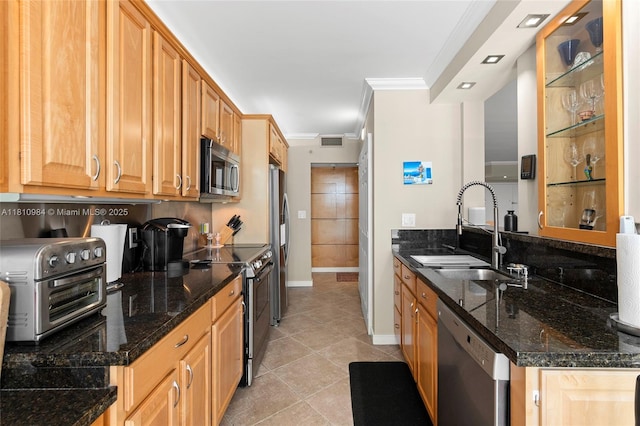 9 Island Ave Unit 505, Miami Beach, FL 33139 - kitchen with appliances with stainless steel finishes, crown molding, light tile patterned floors, and dark stone counters