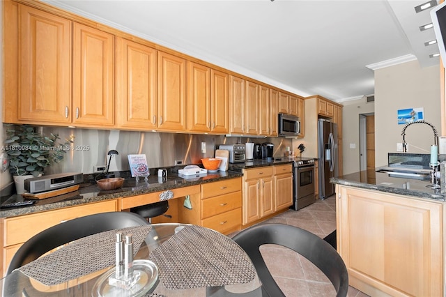 9 Island Ave Unit 505, Miami Beach, FL 33139 - kitchen with stainless steel appliances, ornamental molding, dark stone counters, and backsplash
