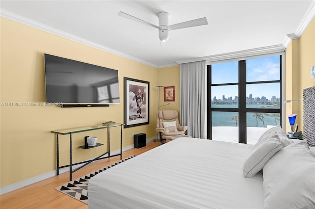 9 Island Ave Unit 505, Miami Beach, FL 33139 - bedroom with crown molding, wood finished floors, and ceiling fan