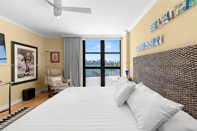 9 Island Ave Unit 505, Miami Beach, FL 33139 - bedroom featuring ornamental molding, wood finished floors, ceiling fan, and a view of skyline