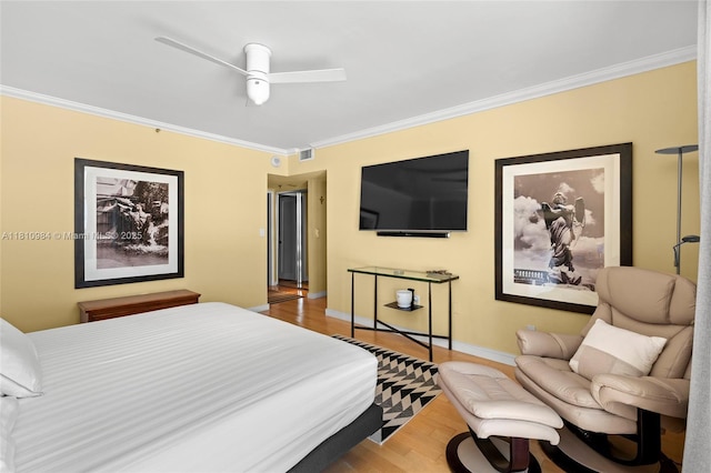 9 Island Ave Unit 505, Miami Beach, FL 33139 - bedroom with ornamental molding, wood finished floors, and a ceiling fan