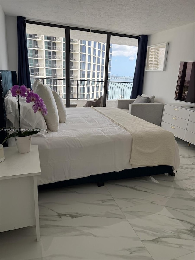 555 NE 15th St Unit 15G, Miami, FL 33132 - bedroom featuring marble finish floors, access to exterior, expansive windows, and a textured ceiling