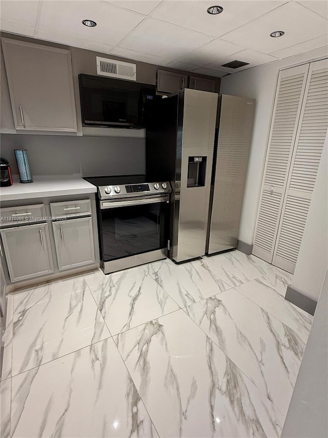 555 NE 15th St Unit 15G, Miami, FL 33132 - kitchen with appliances with stainless steel finishes, gray cabinets, light countertops, and a drop ceiling