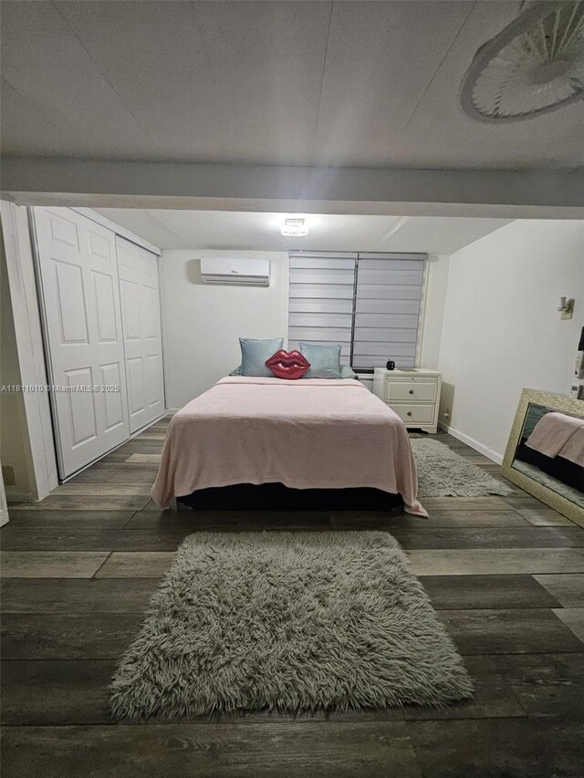 2848 W Marina Dr, Dania Beach, FL 33312 - bedroom with a wall mounted AC, wood finished floors, and baseboards