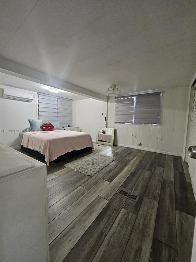 2848 W Marina Dr, Dania Beach, FL 33312 - bedroom featuring a wall unit AC and wood finished floors