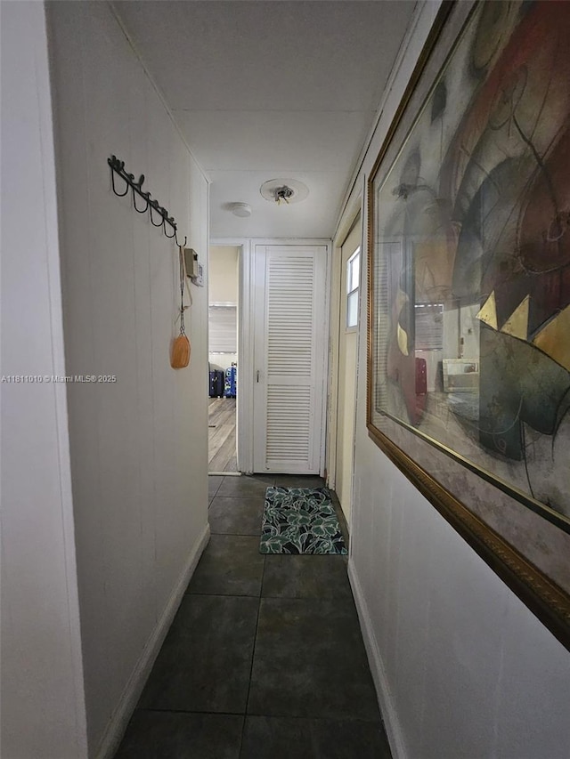 2848 W Marina Dr, Dania Beach, FL 33312 - hall featuring baseboards and dark tile patterned floors