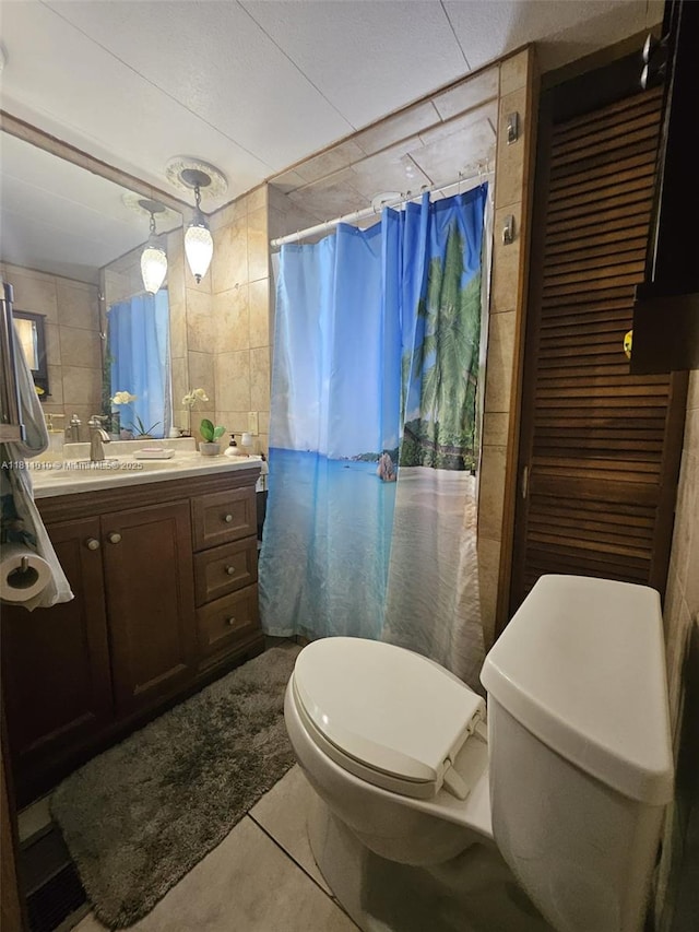 2848 W Marina Dr, Dania Beach, FL 33312 - full bathroom featuring toilet, tile walls, vanity, tile patterned floors, and a shower with shower curtain
