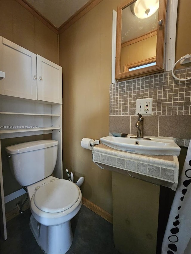 2848 W Marina Dr, Dania Beach, FL 33312 - bathroom featuring toilet, baseboards, crown molding, and backsplash