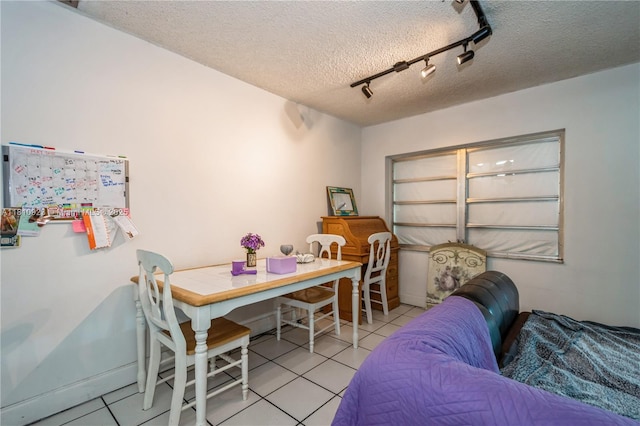 4697 SW 35th Ave, Dania Beach, FL 33312 - dining space with track lighting, light tile patterned flooring, and a textured ceiling