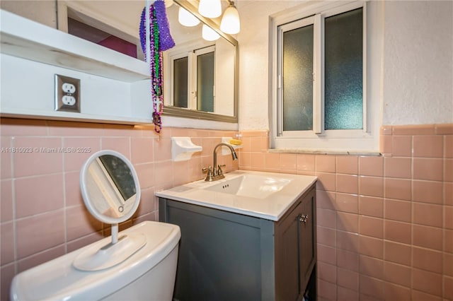 4697 SW 35th Ave, Dania Beach, FL 33312 - bathroom featuring tile walls, vanity, toilet, and wainscoting